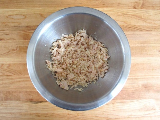Drained tuna in a mixing bowl.