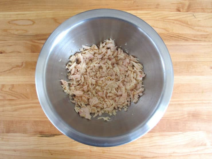 Drained tuna in a mixing bowl.
