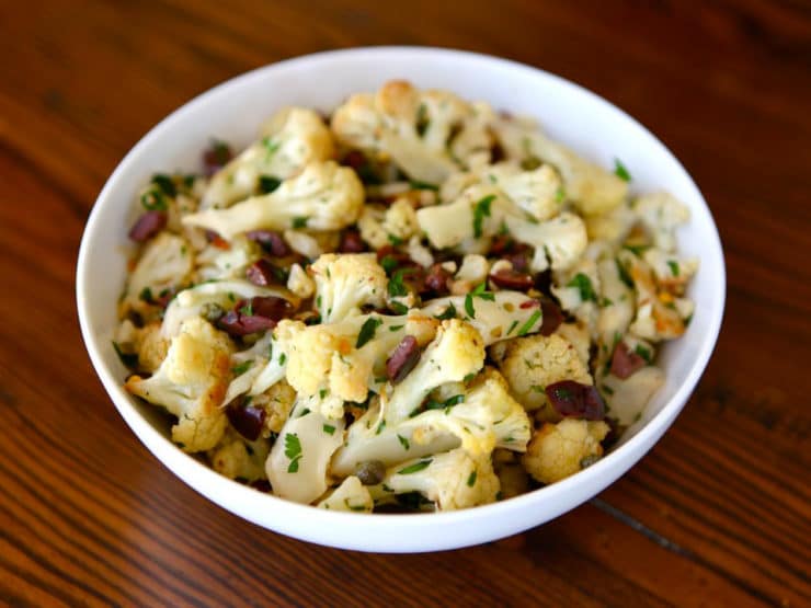 Slant image of Italian Roasted Cauliflower Salad serve on a white bowl.