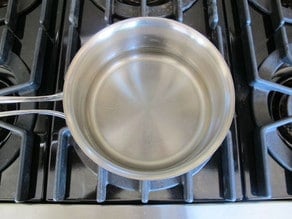 Making simple syrup in a saucepan.