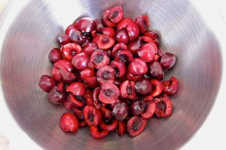 Pitted cherries in a large bowl.