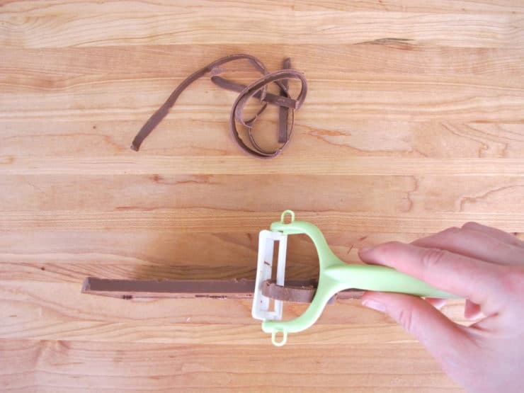 Shaving chocolate in ribbons.
