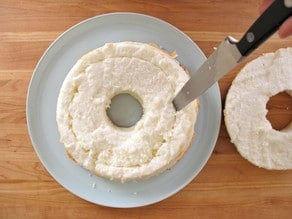 Cutting out a center ring of angel food cake.