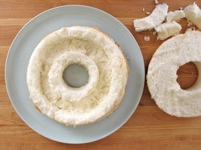 Cutting out a center ring of angel food cake.