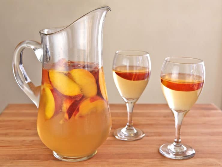 Peach Sangria - Learn to make white sangria with peaches, the perfect cold refreshing party drink for summer.