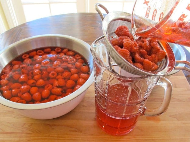 Straining raspberry cordial.