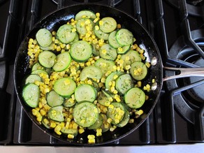 Zucchini rounds in a skillet.