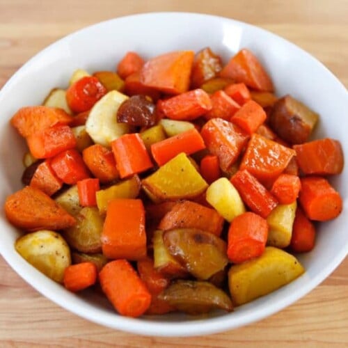 Citrus Honey Glazed mixed vegetables served in a white bowl on top of a wood table