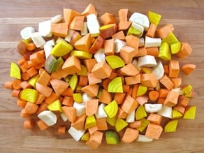 Diced root vegetables on a cutting board.