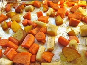 Diced root vegetables on a baking sheet.