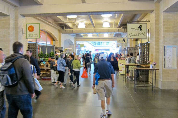 Indoor view of Ferry Plaza Farmer\'s Market - small crowd of shoppers browsing.