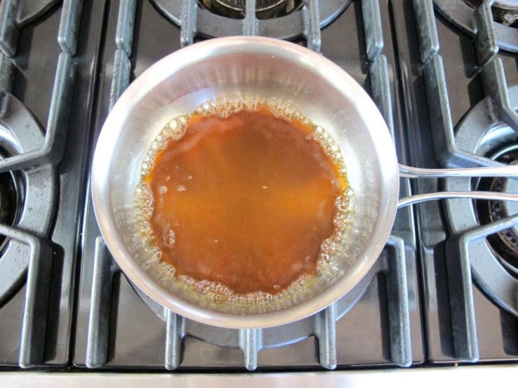 Melting brown sugar in a saucepan.