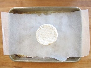 Cheese on a parchment lined baking sheet.