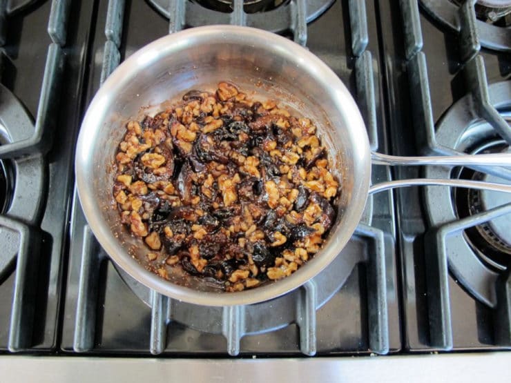 Walnuts stirred into fig syrup.
