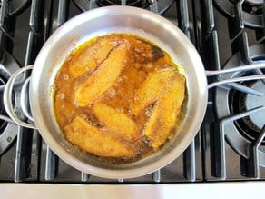 Frying Tilapia in a skillet.