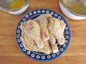 Breaded chicken parts on a plate.