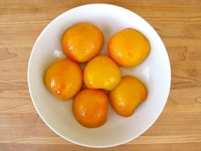 Peach halves in a bowl.