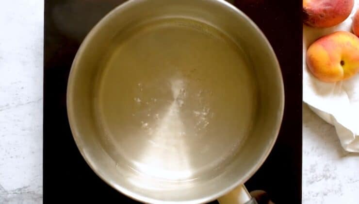 Overhead shot of saucepan filled with clear simple syrup.
