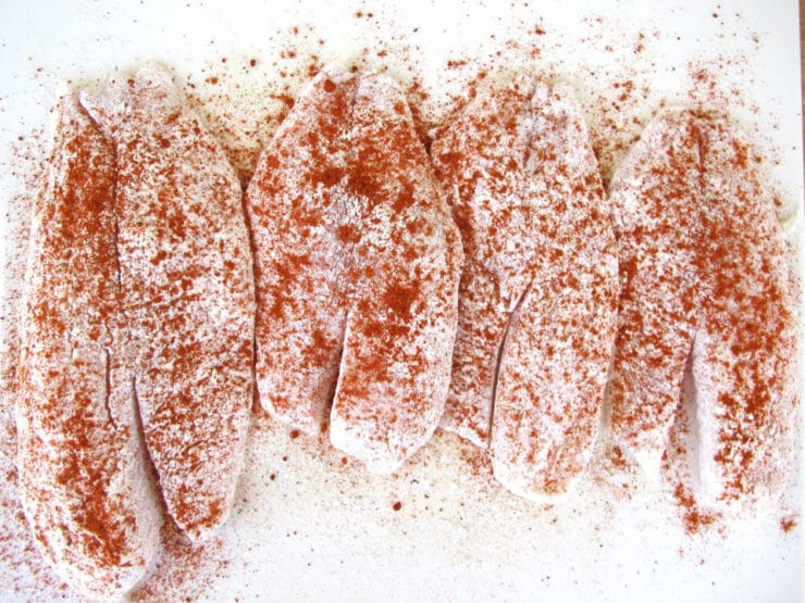 Seasoning tilapia with paprika.