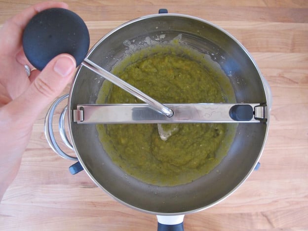 Processing split peas through a food mill.