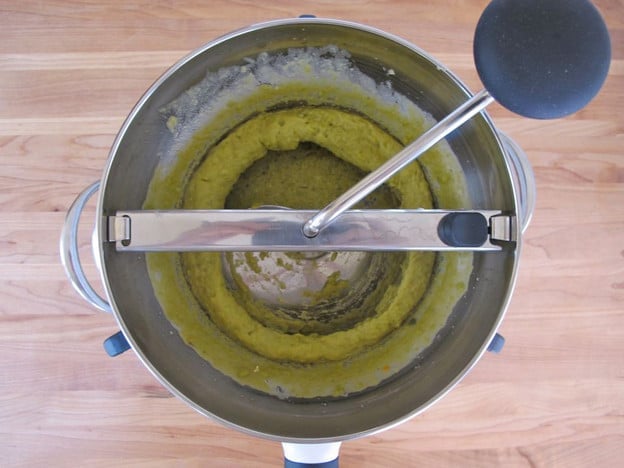 Processing split peas through a food mill.