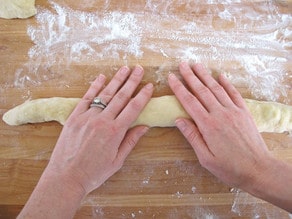 Rolling out log of challah.