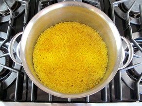 Rice cooking in a stockpot.