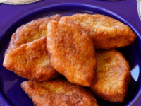 Delicious Keftes de Prassa, fried chicken nuggets, beautifully presented on a purple plate