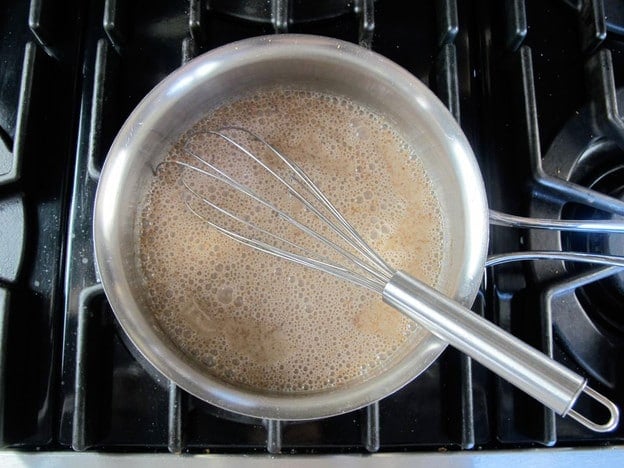 Almond milk and sugar in a saucepan.