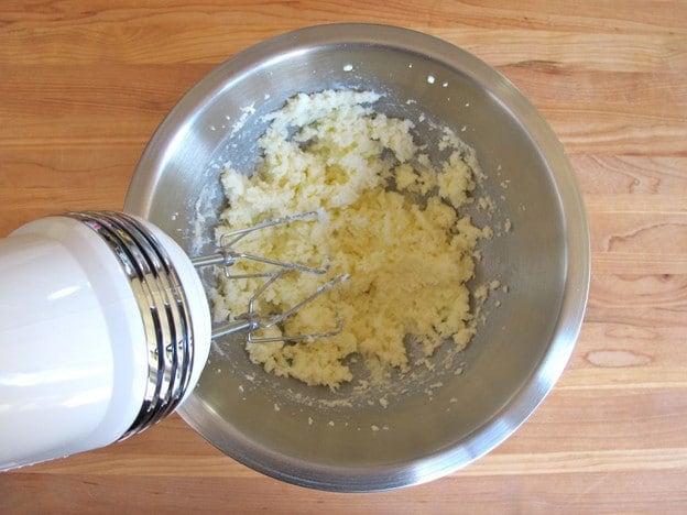Creaming butter and sugar in a mixing bowl.