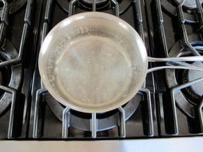 Pot of water boiling on stovetop.