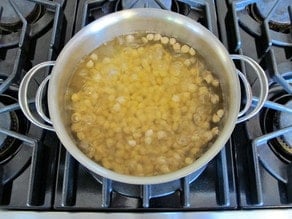 Simmering chickpeas in large pot on stovetop.