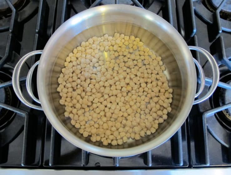 Dried chickpeas covered with water in large pot to soak.