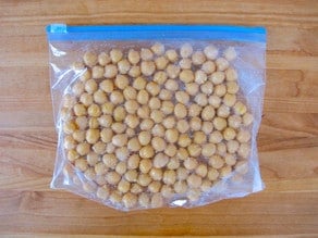 Chickpeas in single layer in plastic zipper bag, ready to freeze.