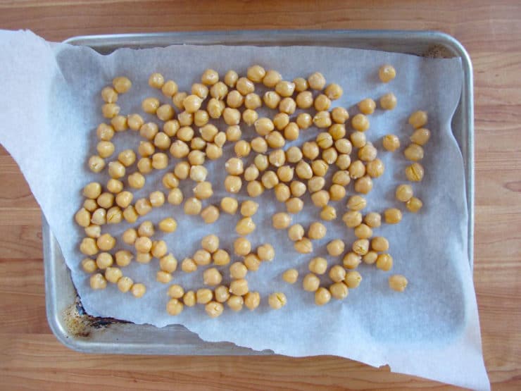 Chickpeas on parchment lined baking sheet ready to freeze.