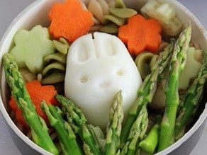 Hard boiled egg bunny in asparagus.
