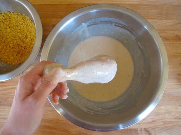 Dipping chicken parts in seltzer batter.