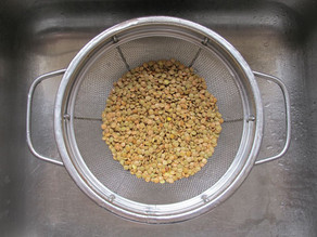 Rinsing lentils to check for impurities.