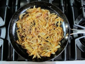Sliced onions in a skillet.