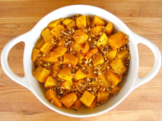 Walnuts over butternut squash in a gratin dish.