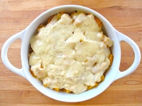 Cheese sauce on top of butternut gratin.