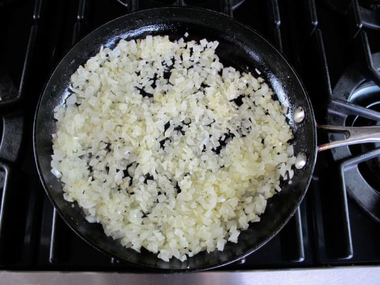 Sauteeing diced onion in a skillet.