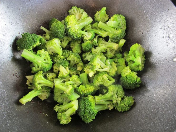 Broccoli florets in a wok.