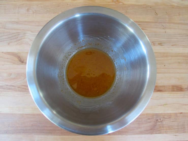 Orange juice marinade in a small bowl.