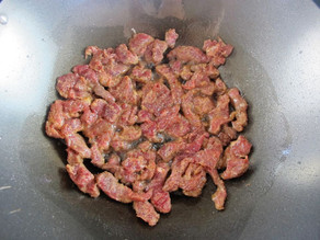 Chopped steak in a wok.