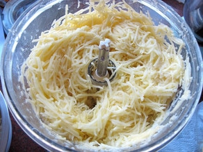 Shredded potatoes in the food processor.