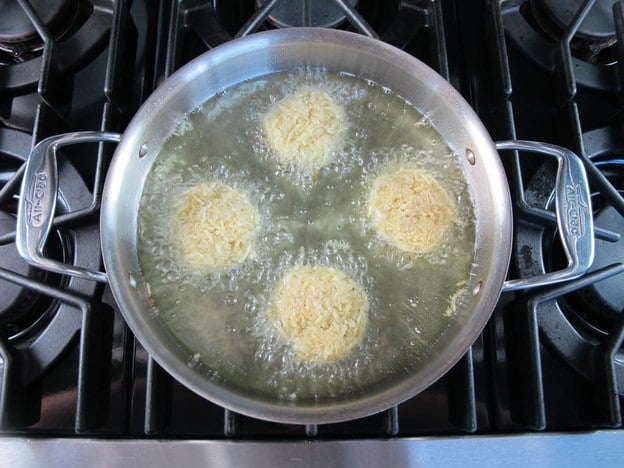 Latkes frying in oil.
