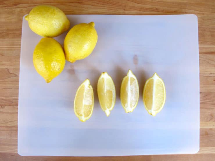 Lemon sliced into lengthwise quarters.