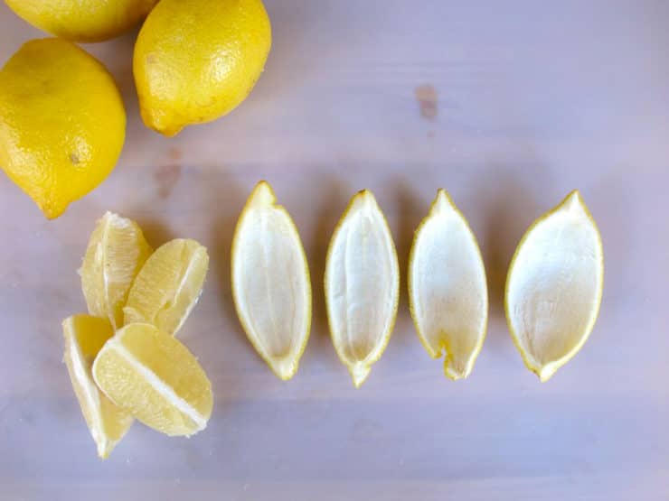 Separating lemon flesh from peel.