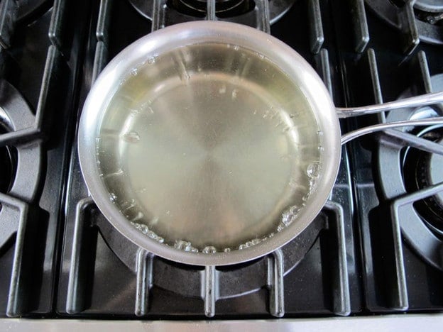 Making simple syrup in a saucepan.